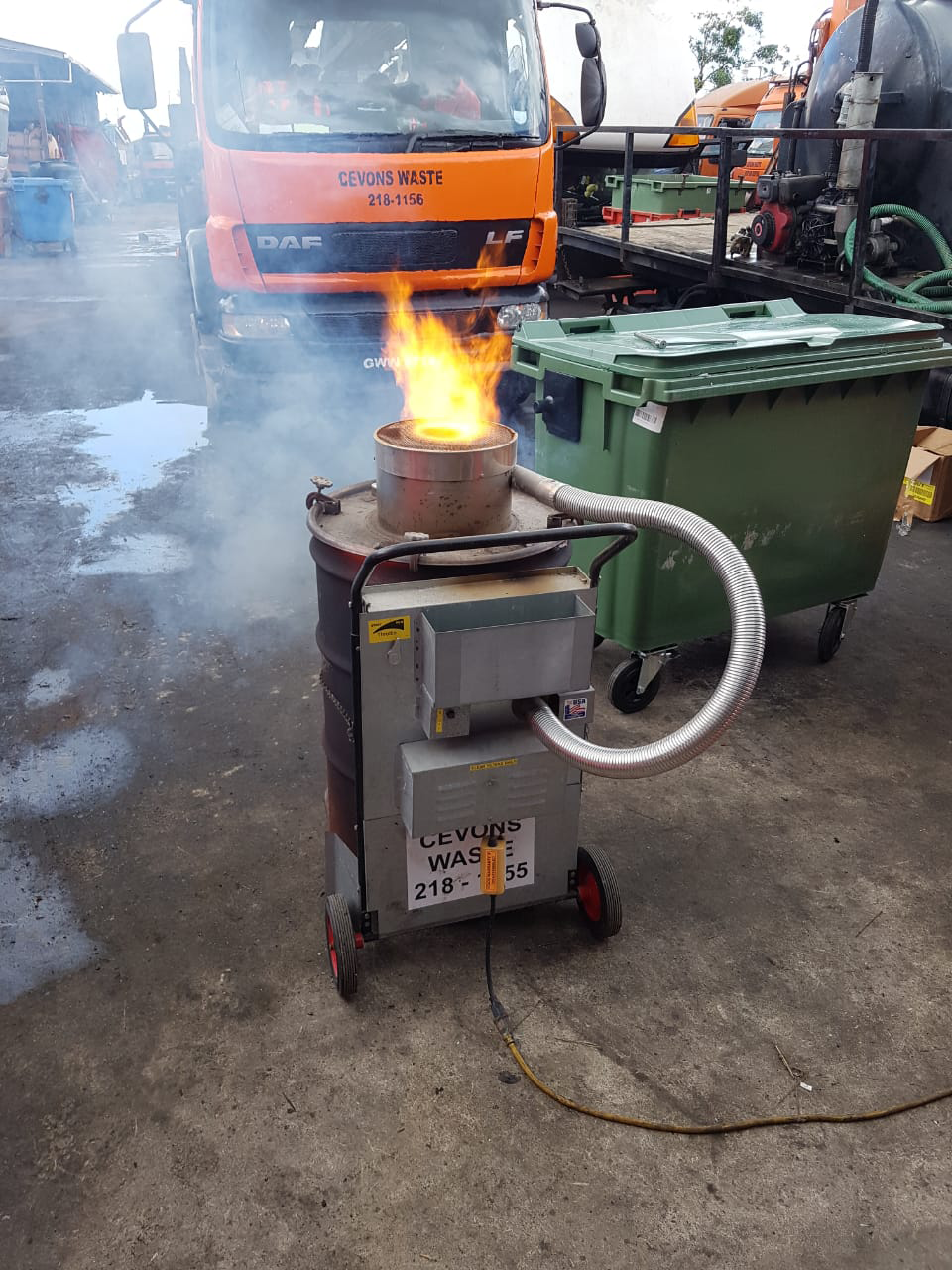 CEVONS barrel incinerator in operation on an industrial site