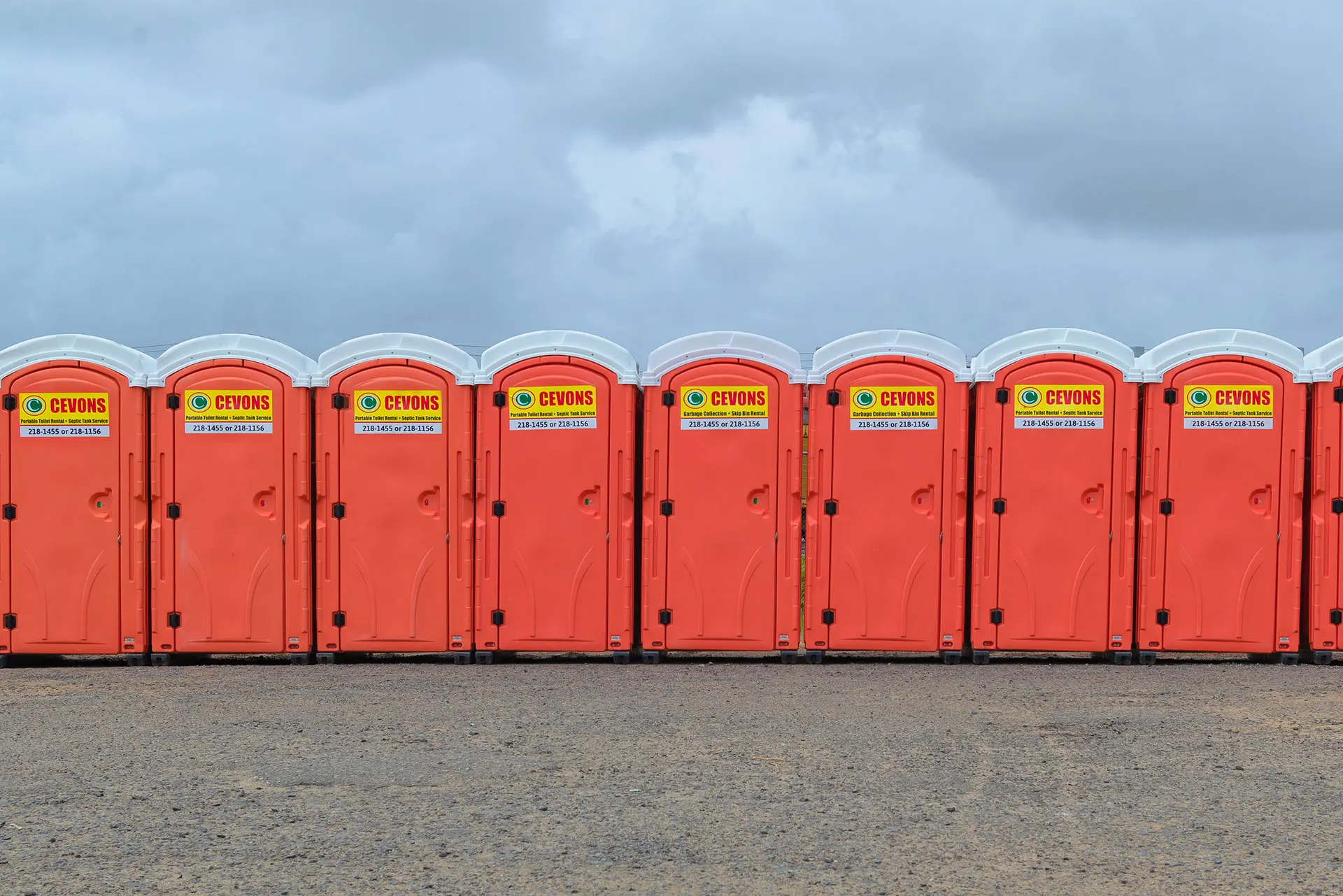 CEVONS technician servicing a portable toilet unit on site